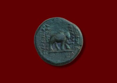 Ancient Parthian coin reverse showing a prominent elephant walking right with surrounding Aramaic/Greek legends.