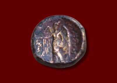 Ancient coin showing Nike standing beside an elephant, holding a wreath, on the reverse of a Seleukos I bronze.