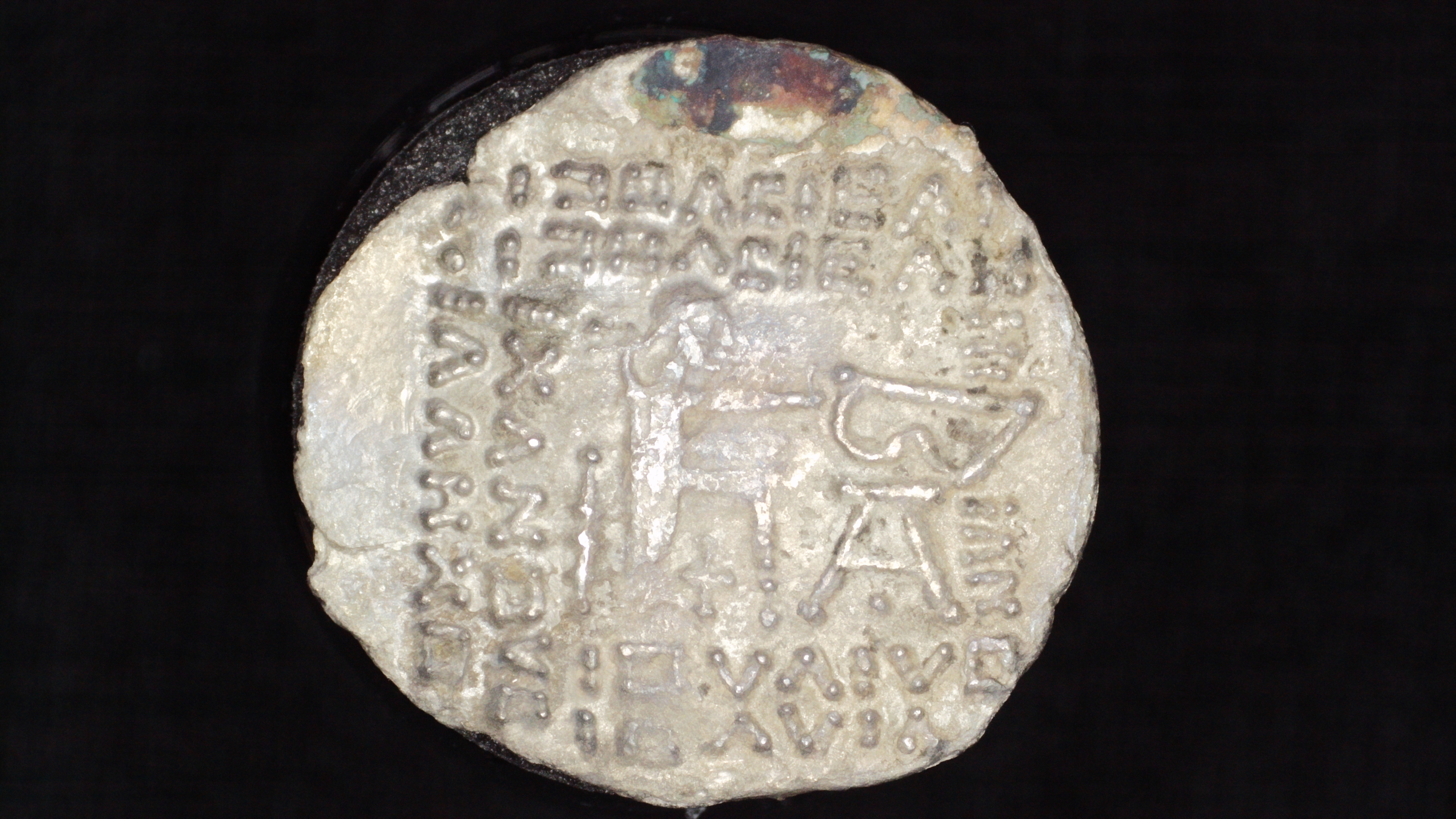 Reverse of Vologases I AR Drachm, seated archer holding bow with monogram 26