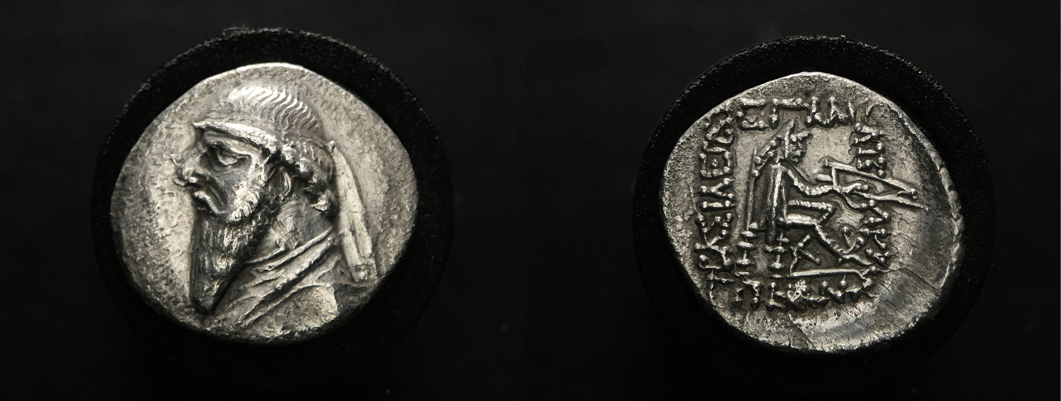 Silver drachm of Mithradates II showing bearded king and seated archer with Greek inscription